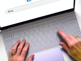 A direct overhead shot of a person searching on Bing on their desktop to show the user experience