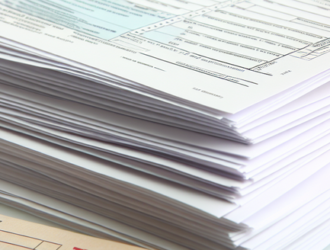 A stack of tax return documents arranged in an orderly fashion